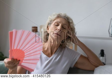 Mature Senior Woman Exhausted With Heat, Swelter, Summer Weather