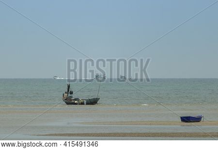 Fisherman's Fishing Boat On Sand At A Fishing Village Beach There Is An Island And Sea Background Wi