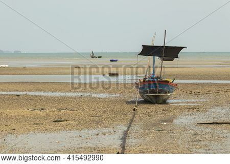 Fisherman's Fishing Boat On Sand At A Fishing Village Beach There Is An Island And Sea Background Wi