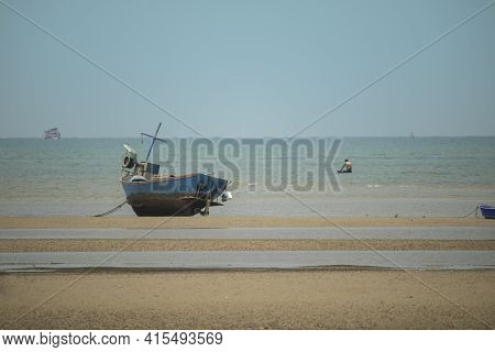 Fisherman's Fishing Boat On Sand At A Fishing Village Beach There Is An Island And Sea Background Wi