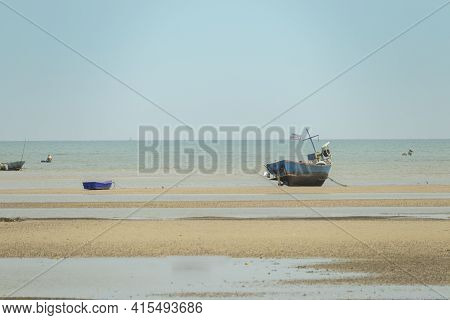 Fisherman's Fishing Boat On Sand At A Fishing Village Beach There Is An Island And Sea Background Wi