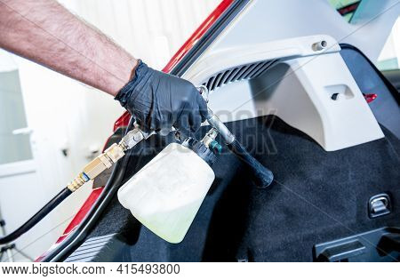 A Car Service Worker Cleans Interiror With A Special Foam Generator