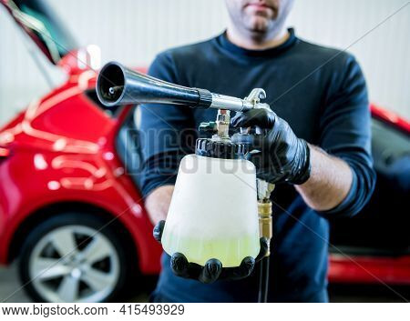 A Car Service Worker Cleans Interiror With A Special Foam Generator