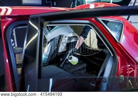 A Car Service Worker Cleans Interiror With A Special Foam Generator