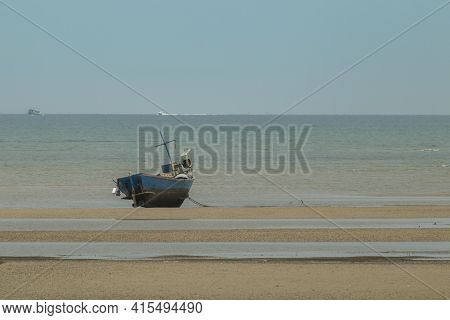Fisherman's Fishing Boat On Sand At A Fishing Village Beach There Is An Island And Sea Background Wi