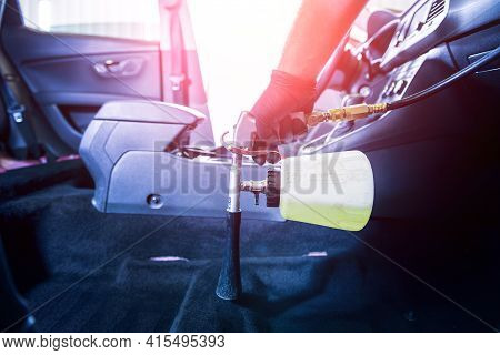 A Car Service Worker Cleans Interiror With A Special Foam Generator