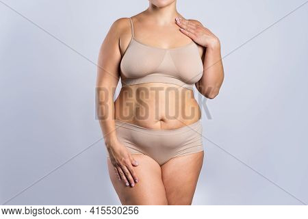 Fat Woman In Beige Underwear On Gray Background, Overweight Female Body