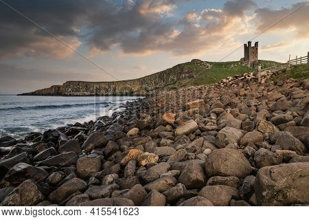 Beautiful Landscape Image Of Dunstanburgh Castle On Northumberland Coastline In England During Late 