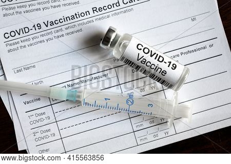 Covid-19 Vaccine Bottle And Syringe Are On Coronavirus Vaccination Record Card, Medical Form Require
