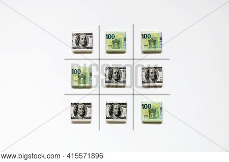 Finished Standoff Game Of Tic-tac-toe From Dollar And Euro Banknotes On White Background