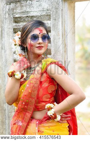 Portrait Of Pretty Young Indian Girl Wearing Traditional Saree And Jewellery, Playing With Colors An