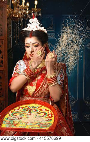 Portrait Of Beautiful Indian Woman Wearing Traditional Indian Saree, Gold Jewellery And Bangles Thro
