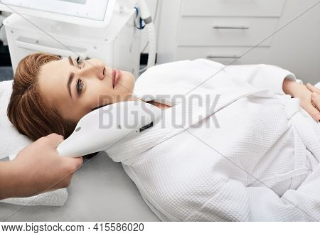 Beautician Removes Brown Spots On A Womans Skin In The Beauty Salon. Skin Rejuvenation Of A Beautifu