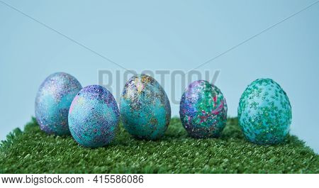 Blue Painted Eggs With Bright Shiny Gliter On Grass