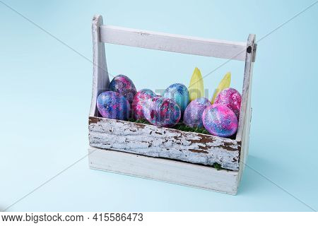 Colorful Painted Eggs With Bright Shiny Gliter In Wooden Basket