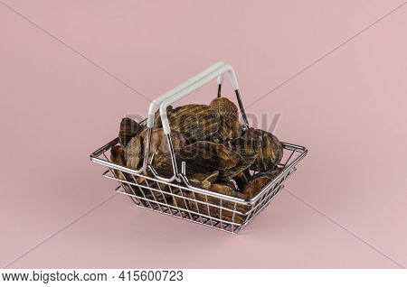 Shopping Basket With Dog Treats On A Pink Background. Natural Treats In A Metal Basket. Dried Bovine