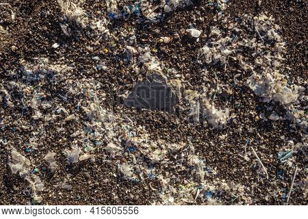 Small plastic parts and microplastics on the sand beach. Global ocean pollution. Microplastic in water and food. Global ocean pollution. Microplastic environment problem.