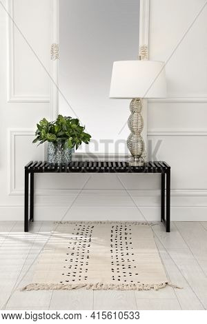 Console Table With Lamp, Bouquet Of Green Branches And Mirror In Room. Interior Design