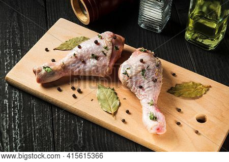 Chicken Legs On A Cutting Board With Spices. The Idea To Cook Lunch Or Breakfast In A Street Cafe. V