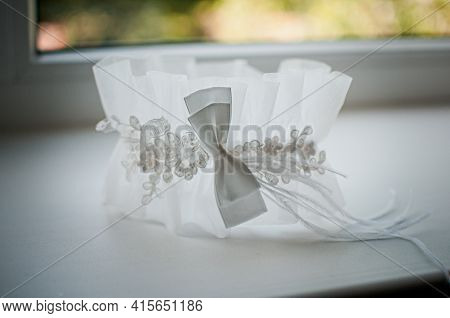 White Wedding Garter On The White Windowsill