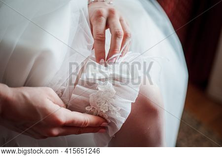 Bride Wearing Wedding Garter On The Leg
