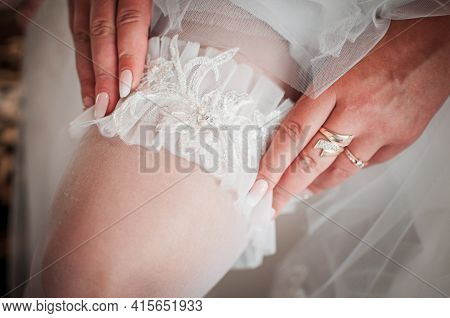 White Wedding Garter On The Brides Leg