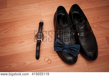 Shoes Gold Rings And Wristwatch On The Table