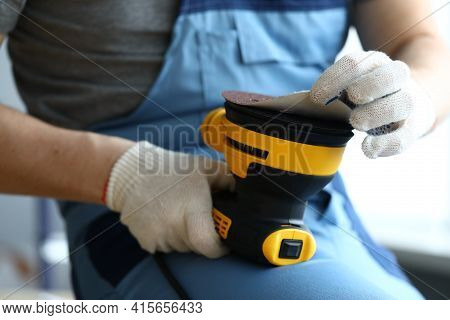 Master Holds Sander In His Hands And Changes Disc