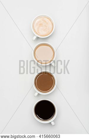 Top View Of Different Freshy Made Coffee Drinks With Milk On White.
