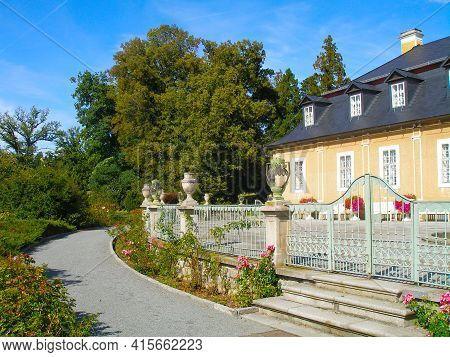 View Of The Rear Wing Of A Renovated House With Landscaped Surroundings.