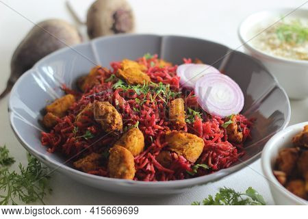 One Pot Rice Preparation With Basmati Rice, Beetroot, Onions And Spices. Served With Air Fried Chick