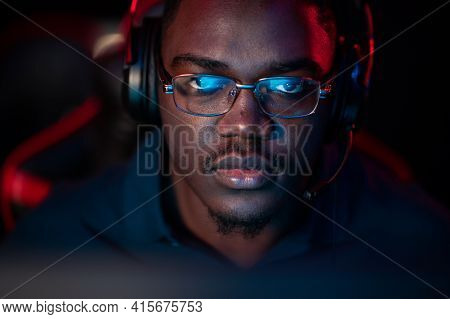 An African Guy Wearing Headphones And Glasses Leads An Online Stream During The Computer Games Champ
