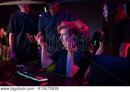 A Cute Guy Is Worried About Losing A Computer Game, His Friends Calm Him Down