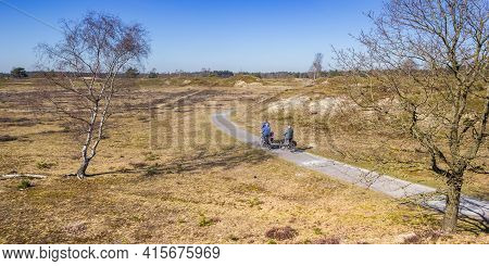 People Riding Their Bicycle In The Dunes Of The National Park Drents-friese Wold, Netherlands