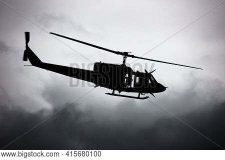 Untitled Helicopter Flying In The Sky Photo. Helicopter With No Markings. Silhouette Shot. Heli With