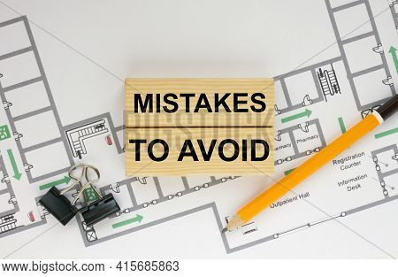 Construction Drawings And Wooden Bars With Text Mistakes To Avoid And Paper Clips. Architecture And 