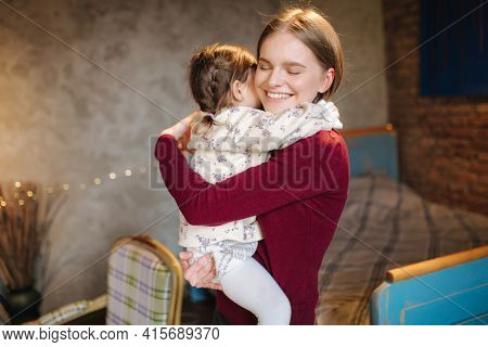 Adorable Little Girl Hug Her Beautiful And Young Godmother. Portrait Of Happy Woman Hug Her Goddaugh
