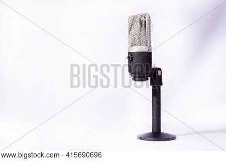 Professional Condenser Microphone On A Pedestal Isolated With White Background, Selective Focus.