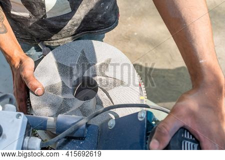 Man's Hands While Grinding Stones To Grind Corn