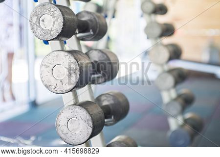 Rows Of Dumbbells In The Gym. Sports Equipment In The Gym. Empty Gym During Quarantine.