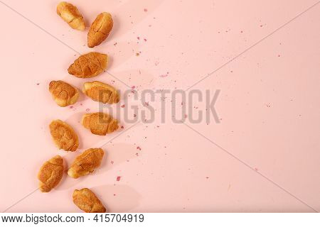 Fresh Ruddy Croissants On A Light Table With Crumbs, Top View, Place For Text. Modern Bakery Concept