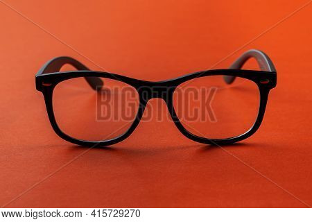 Eyeglasses On Orange Background, Myopia Or Presbyopia.  Eyesight Correction. Fashion Accessories.