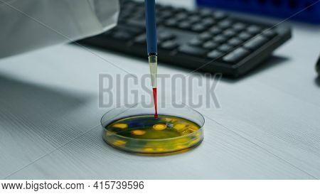 Close Up Of Scientist Using Micropipette For Analysing Blood Sample
