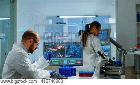Laboratory Medical Stuff Disscussing About Vaccine Development Holding Test Tube