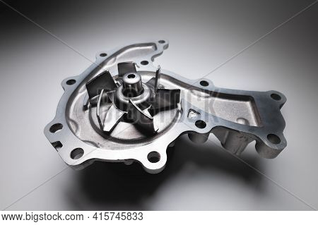 Water Pump Of The Internal Combustion Engine Cooling System. Contrasting On A Gray Gradient