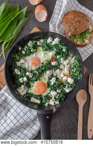 Shakshouka - Middle Eastern Traditional Dish With Poached Eggs And Wild Garlic