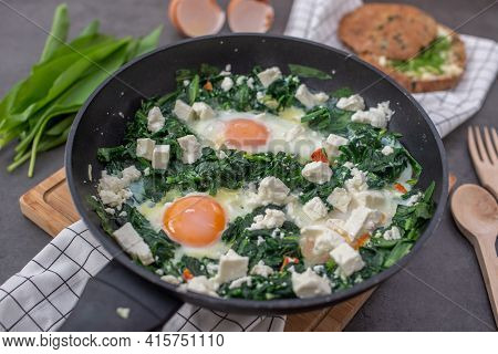 Shakshouka - Middle Eastern Traditional Dish With Poached Eggs And Wild Garlic