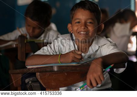 Bluff, Nicaragua. 03-17-2019. Portrait Of A Smiling Boy Writing At School In The Town Of Bluff In Ni