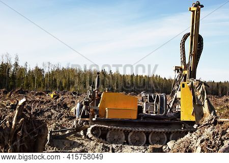 Mini-drilling Rig On Crawler Track On Site Of Sawn Forest Where Large-scale Enterprise Will Be Built