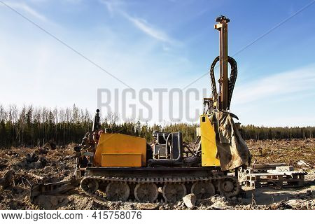 Mini-drilling Rig On Crawler Track On Site Of Sawn Forest Where Large-scale Enterprise Will Be Built